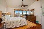 The Master Bedroom on the main floor has a king-size bed, access to the outdoor patio with views of the Pacific, a large walk-in closet and a private bathroom